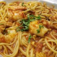 Clams, Squid and Shrimp · Clams, squid, shrimp in a spicy red sauce over linguini.