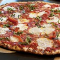 Margarita Pizza · Vine-ripened roasted tomato, aged Parmesan, fresh mozzarella, basil and olive oil.