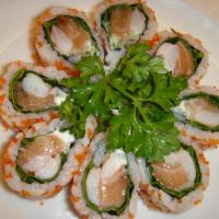 Boston Flower Roll · Raw. Salmon, shrimp, cucumber, flying fish roe, mayo, and green vegetables.