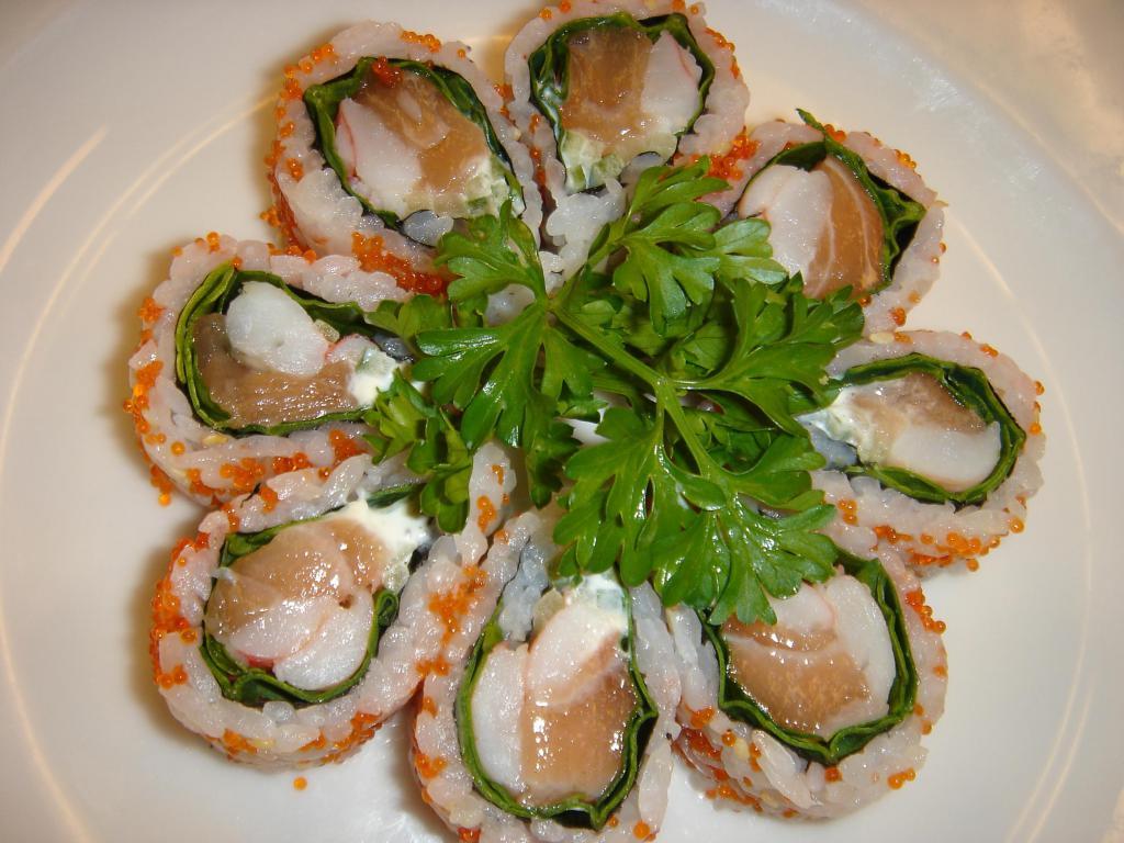 Boston Flower Roll · Raw. Salmon, shrimp, cucumber, flying fish roe, mayo, and green vegetables.