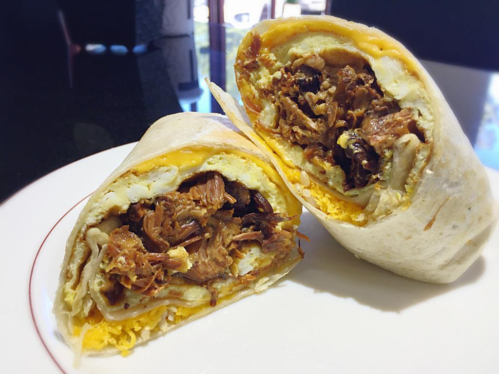 Pulled Pork Breakfast Burrito · Pulled Pork, Scrambled Eggs, Melted Cheese Wrapped in Flour Tortilla. Served with Chips & Salsa