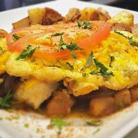 Cajun Chicken Omelet · Cajun chicken, chopped tomato, caramelized onions and melted cheddar cheese. Served with toa...