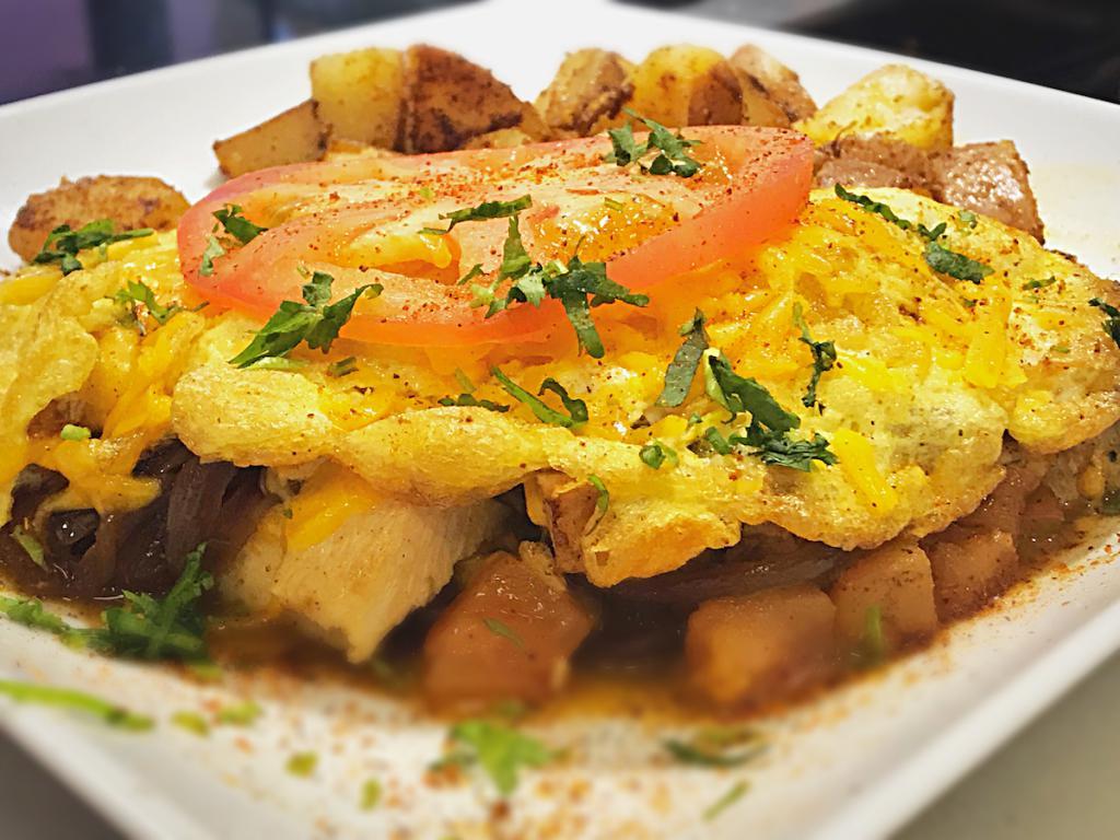 Cajun Chicken Omelet · Cajun chicken, chopped tomato, caramelized onions and melted cheddar cheese. Served with toast and home style potatoes.