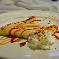 Peanut Butter and Jelly Crepe · Dessert crepe filled with creamy peanut, garnished with raspberry and caramel sauce and whip...