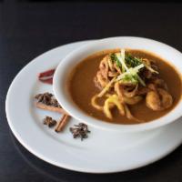 Mixed Seafood Curry · A medley of prawns, calamari and salmon in a masala sauce. Served with choice of 2 sides.