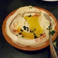 Hummus · A delicious middle eastern blend of garbanzo beans, tahini, fresh garlic, lemon and olive oil.