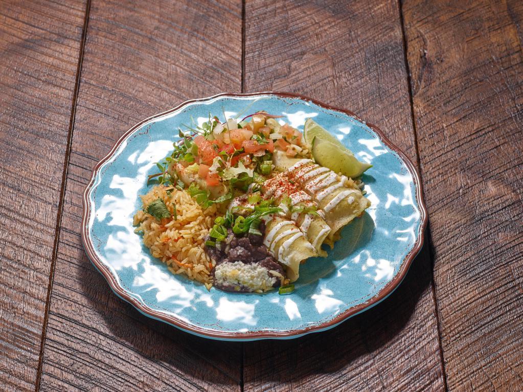 Enchiladas Suizas plate · 3 green chicken enchiladas with jack cheese and sour cream. Served with side of beans and rice.