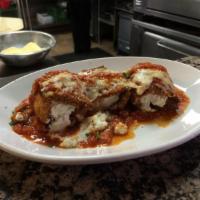 Eggplant Rollatini · Fried breaded eggplant rolled, filled with our seasoned ricotta, and topped with marinara sa...