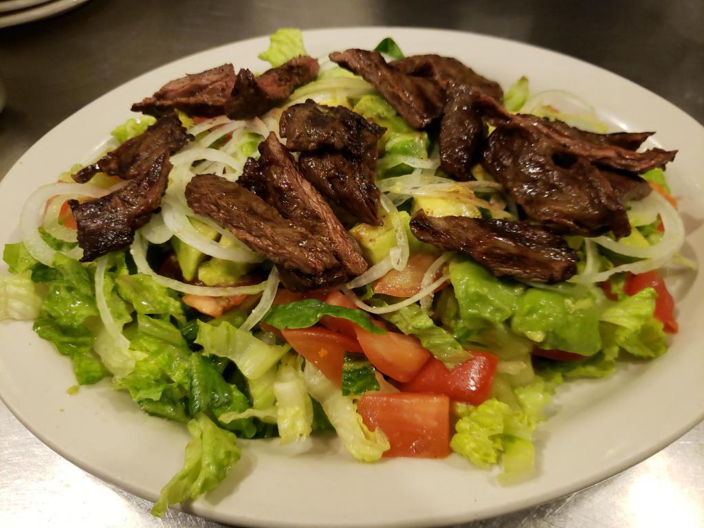 Steak Salad · Lettuce, tomatoes, onions, avocado and skirt steak.