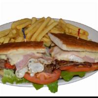 Chivito al Sandwich · Made with steak, ham, cheese, eggs, bacon, lettuce, tomatoes, onions and peppers. Served wit...