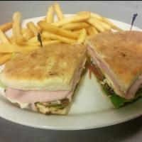 Lomito Completo Sandwich · Made with loin meat, ham, eggs, lettuce, tomatoes and cheese. Served with fries.