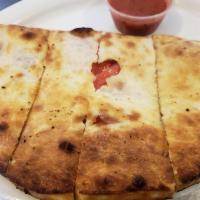 Kussifay Calzone · Stuffed with fresh mozzarella cheese, ham, heart of palm, red peppers, eggs and salsa golf.