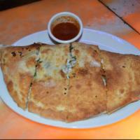 Spinach Calzone · Stuffed with fresh mozzarella cheese, spinach, Alfredo sauce and Parmesan cheese.