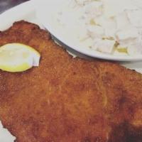 Chicken Milanese · Breaded chicken breast with french fries.