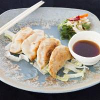 Gyoza · Home made pork dumplings with chive and egg .