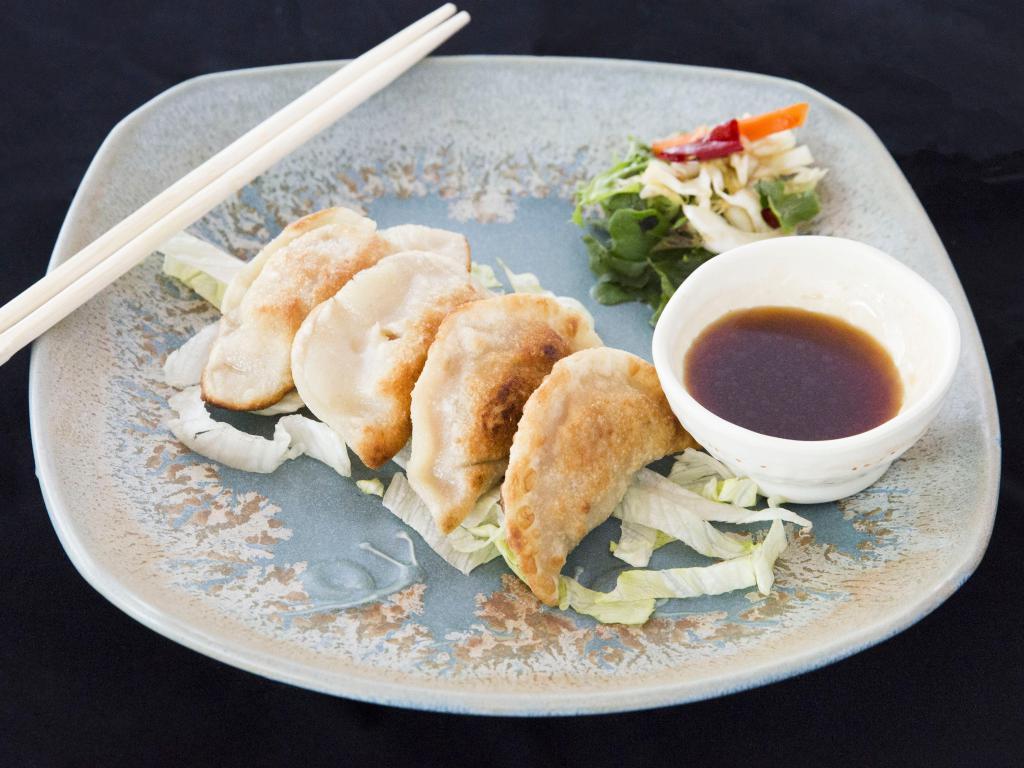 Gyoza · Home made pork dumplings with chive and egg .