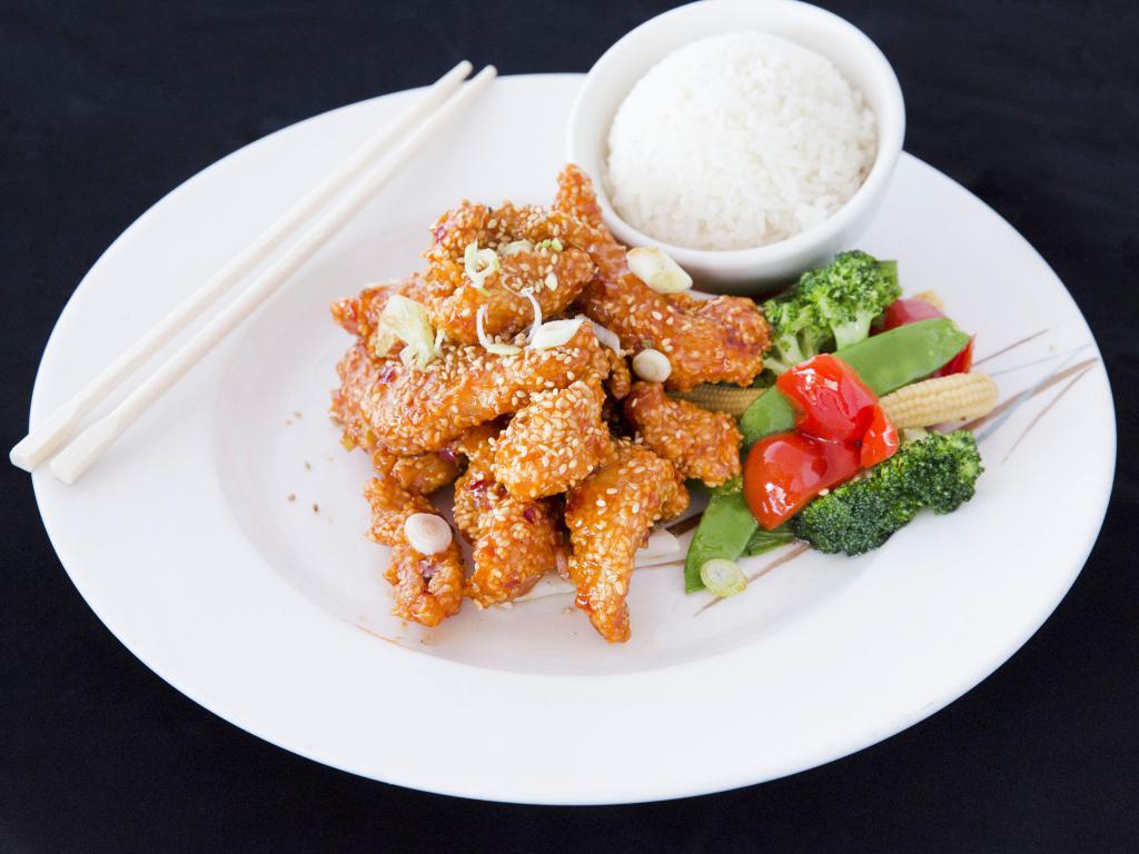 John Holly's Sesame Chicken · Strips of white meat chicken coated with sesame seed, slightly fried and stir-fried in mild/medium spicy tomato sauce with vegetables. Spicy.