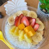 Acai Tropical Paradise Bowl · A base of acai blended with bananas and berries topped with bananas, strawberries, mango, pi...