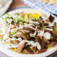 Lamb & Beef Gyro Plate and Soda · With choice of sauce. Served with basmati rice, Greek salad, pita with hummus, and tradition...