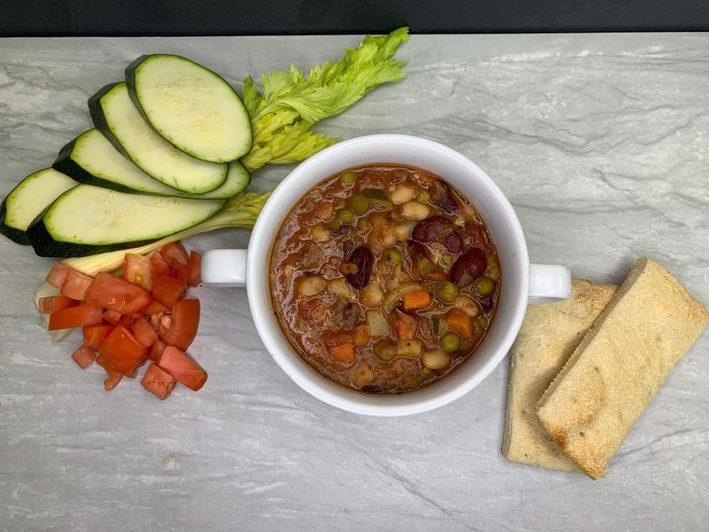 Minestrone Soup · red & white bean, zucchini, onions, carrots, plum tomatoes, penne, grated parmigiana cheese in a reach tomato red broth, Served with homemade garlic bread.