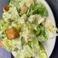 Caesar Salad · Romaine lettuce, crunchy croutons, Caesar dressing, and grated parmigiana cheese. Served wit...
