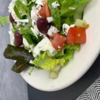 Greek Salad · lettuce, tomatoes, cucumbers, red onions, Kalamata olives, feta cheese, stuffed grape leaves...