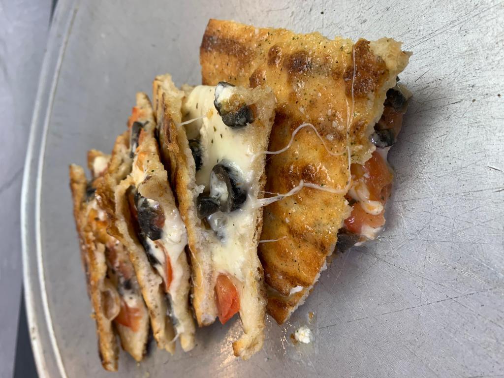 Spicy Greek Panini · Spicy. Mozzarella and feta cheese with tomato, black olives oregano, and touch of olive oil. Glazed with garlic sauce.