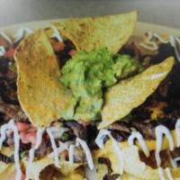 Nachos Supreme · Your choice of meat and regular chips, topped with refried beans, black olives, pico de gall...