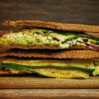 Veggie Toasty · Flattened toasted whole wheat baguette topped with avocado, red onion, tomato and grilled zu...
