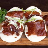 Beijing Roast Duck · Slow roast duck with steamed rice buns with hoisin sauce.