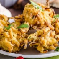 Vegetable Pakora · Crisp golden potato and onion bites cooked with a selection of spices in gram fl our batter ...