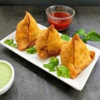 Samosas · Three freshly fried samosa with dipping sauces