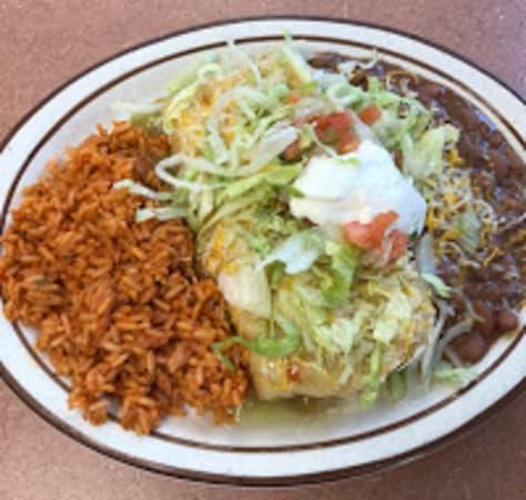 Chimichanga Platter · Crispy fried burrito, choice of meat and chile, topped with topped with cheddar-jack cheese, lettuce and tomato and sour cream. Served with rice and beans. 760-1130 calories.