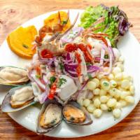 Ceviche de Mariscos · Seafood combination ceviche, no fish. Marinated in lime juice with red onions and blend of s...