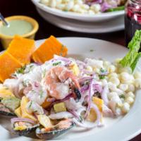 Ceviche Mixto de Mango · Seafood combination with mango marinated in lime juice with red onions and a blend of spices...