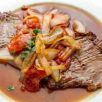 Bistec Encebollado · Beef steak with marinated onions and tomatoes with rice and french fries. 