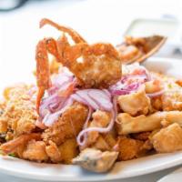 Jalea · Deep-fried pieces of squid, shrimp and fish topped with hot spicy onions salad, mussels and ...