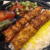 Chicken Lule Kabob Plate · Marinated ground chicken. Served with basmati rice, grilled tomato, jalapeno, pita bread and...