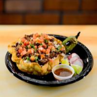 Asada Tostada Rice Bowl · Tortilla shell filled with refried beans, basmati rice and pico de gallo. Topped with sour c...
