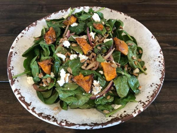 Roasted Butternut Squash Spinach Salad · Spinach, roasted butternut squash, Italian farro, and red onion tossed in a house-made balsamic Dijon vinaigrette, topped with goat cheese sunflower seeds. Vegetarian.
