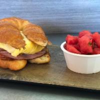 Toluca Croissant Sandwich · scrambled eggs, provolone cheese, shaved black forest ham, herb tomato, and dijonaise on a t...
