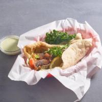 Gyro Wrap · Lamb and beef mix. Served on freshly baked bread with cucumber sauce, lettuce, tomatoes, oni...
