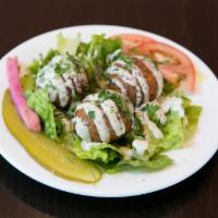 FALAFEL PLATE · Falafel, rice, hummus, tahini, romaine, tomatoes, and pickles. Served with warm pita bread a...