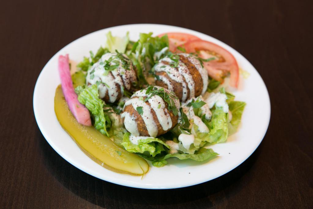 FALAFEL PLATE · Falafel, rice, hummus, tahini, romaine, tomatoes, and pickles. Served with warm pita bread and a side of soup or house salad.