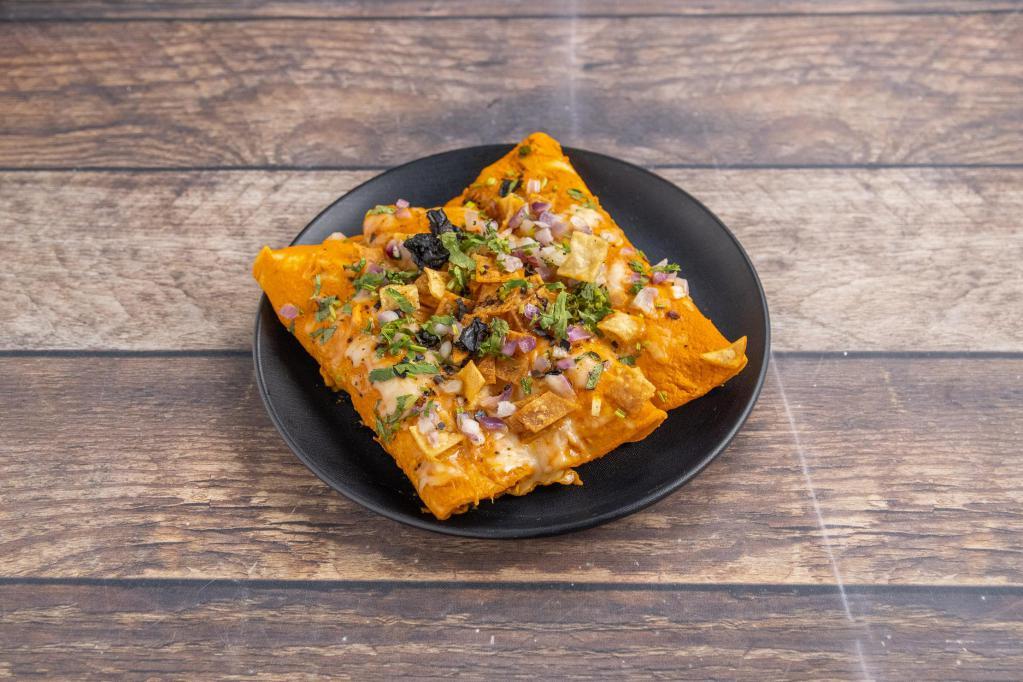 Braised Chicken Enchilada Suizas · Roasted tomato cream sauce, house cheese blend, tortilla strips, crumbled pasilla chilis, red onions and cilantro.