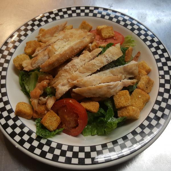 Caesar Salad with Chicken · Romaine lettuce with Parmesan cheese, croutons and tomatoes in our creamy Caesar dressing.
