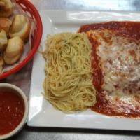 Chicken Parmigiana · Breaded chicken smothered in marinara sauce and baked with mozzarella cheese. Comes with spa...