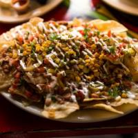 Nacho Libre · Homemade corn tortilla chips topped with our Jefe's Queso Dip, charro beans, pico de gallo, ...