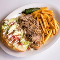 Torta Azteca · Mexican style poboy on toasted torta loaf bread, dressed with refried beans, queso fresco, t...
