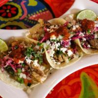Seafood Tacos (2) · Tacos dressed with seasoned red cabbage, pico de gallo, queso fresco, and our delicious home...